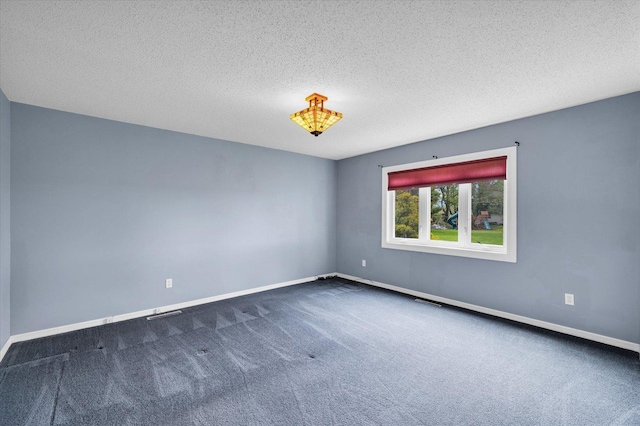 unfurnished room with carpet flooring, a textured ceiling, baseboards, and visible vents