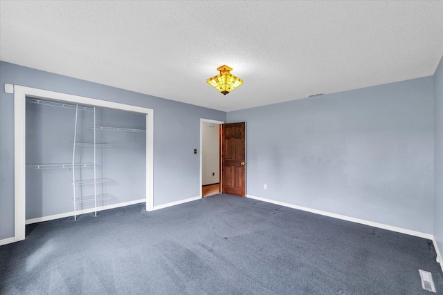 unfurnished bedroom featuring a closet, baseboards, carpet flooring, and a textured ceiling