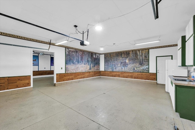 garage with a sink and a garage door opener