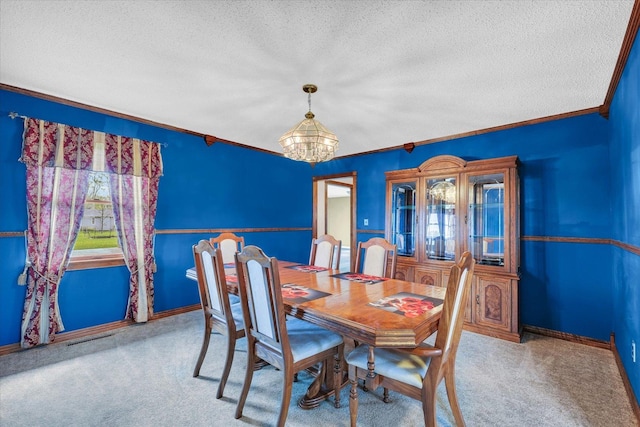 dining area featuring a textured ceiling, carpet, and a chandelier