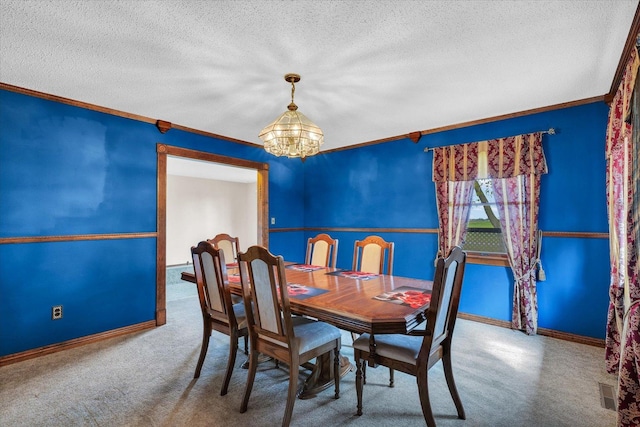 carpeted dining area featuring crown molding, a textured ceiling, a chandelier, and baseboards