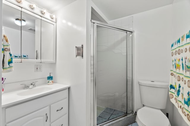 bathroom featuring vanity, a stall shower, and toilet