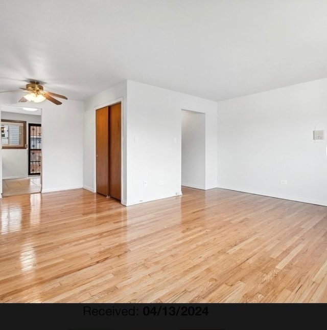 7019 N Ridge Blvd Unit 3B, Chicago, IL 60645 - empty room featuring light wood-style flooring, a ceiling fan, and baseboards