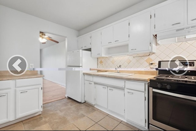 7019 N Ridge Blvd Unit 3B, Chicago, IL 60645 - kitchen featuring stainless steel range with gas stovetop, a sink, custom exhaust hood, and decorative backsplash
