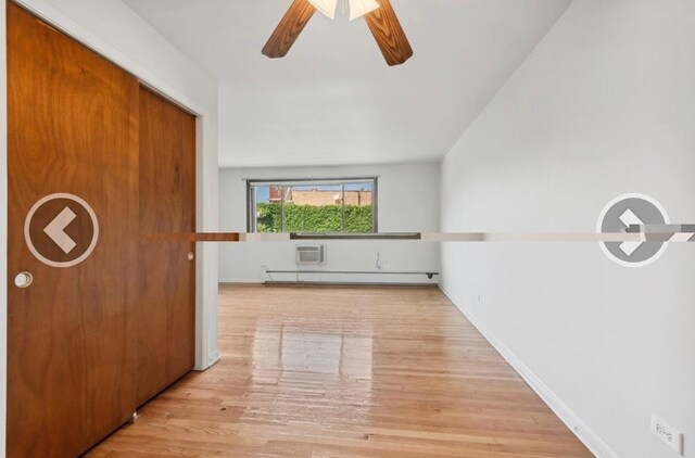 7019 N Ridge Blvd Unit 3B, Chicago, IL 60645 - hall with wood finished floors, a baseboard radiator, and baseboards