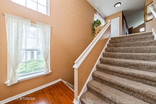 stairs featuring baseboards and wood finished floors