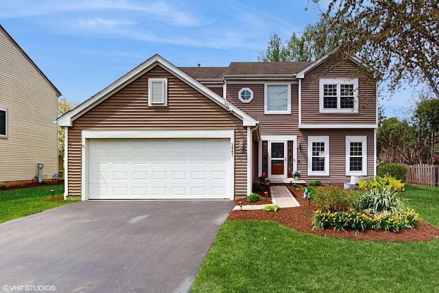traditional home with driveway, a front yard, and a garage