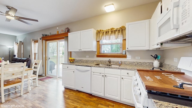 kitchen with white cabinetry, a ceiling fan, a sink, and white appliances