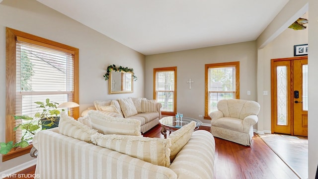 living area featuring baseboards and wood finished floors