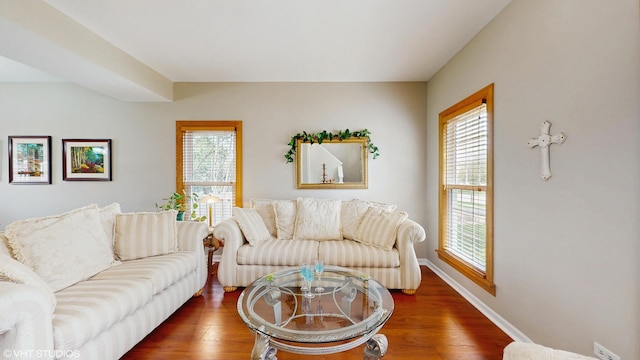 living area featuring baseboards and wood finished floors