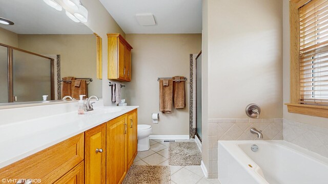 bathroom with vanity, tile patterned flooring, a shower stall, and toilet