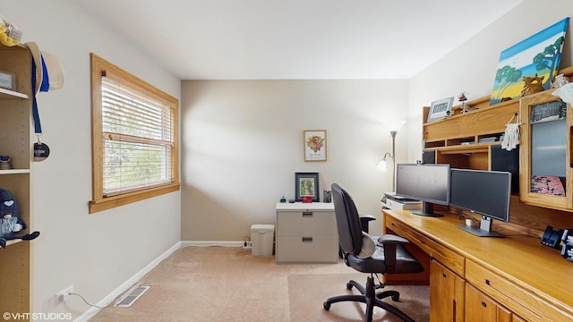 office area featuring baseboards, light carpet, and visible vents