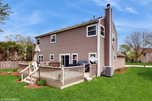 rear view of house featuring cooling unit, a chimney, a wooden deck, a yard, and an outdoor living space