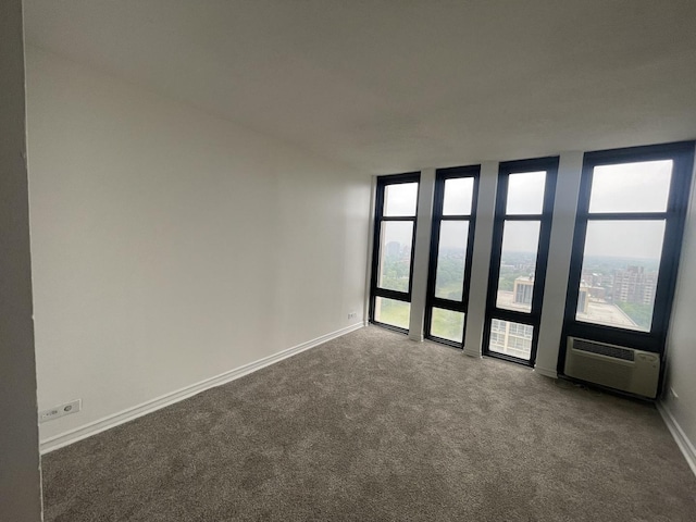 6700 S S Shore Dr Unit 21B, Chicago, IL 60649 - carpeted empty room featuring a wall mounted air conditioner and baseboards