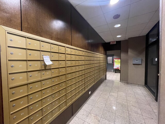 6700 S S Shore Dr Unit 21B, Chicago, IL 60649 - hallway featuring mail area, a paneled ceiling, recessed lighting, and wood walls