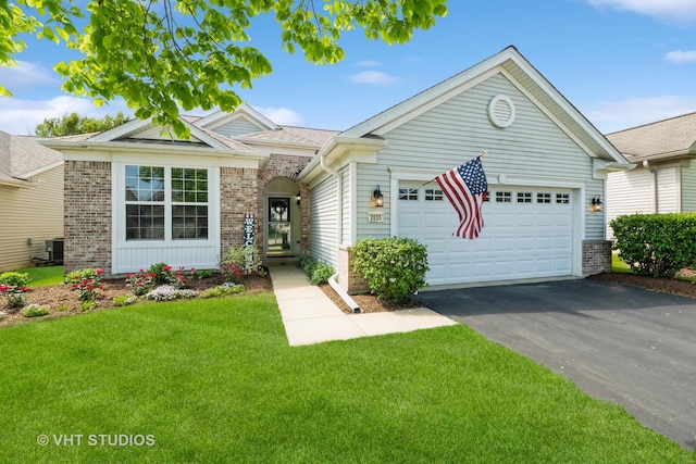 2835 Cascade Falls Cir, Elgin, IL 60124 - view of front of property with asphalt driveway, an attached garage, brick siding, a front yard, and cooling unit