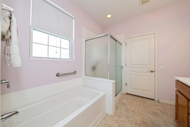 2835 Cascade Falls Cir, Elgin, IL 60124 - bathroom with vanity, a stall shower, a garden tub, recessed lighting, and baseboards