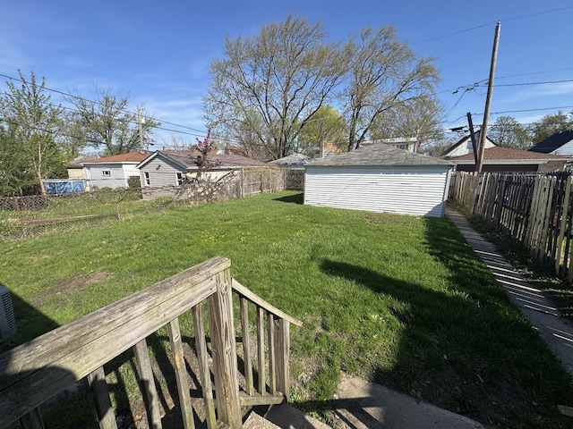 view of yard featuring an outdoor structure and a fenced backyard