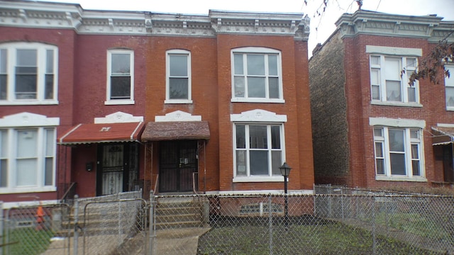 1910 S Spaulding Ave, Chicago, IL 60623 - townhome / multi-family property with brick siding and a fenced front yard