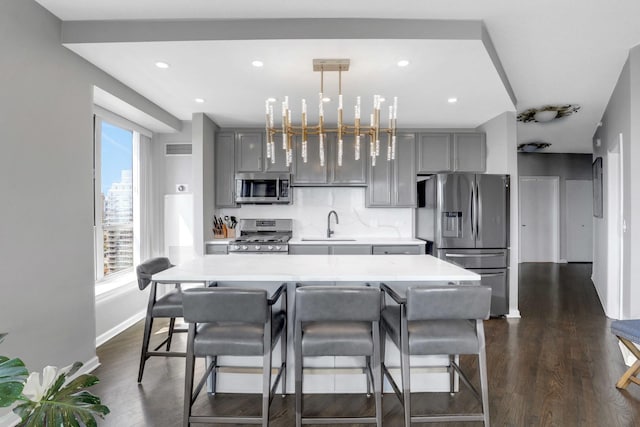kitchen with visible vents, a sink, gray cabinets, and appliances with stainless steel finishes