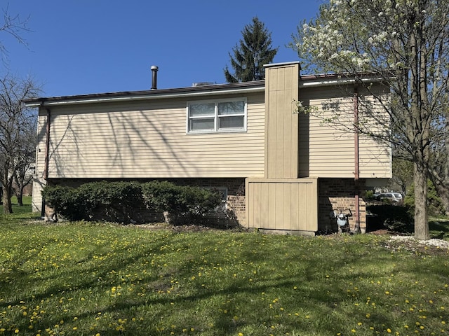 view of property exterior featuring a lawn and brick siding