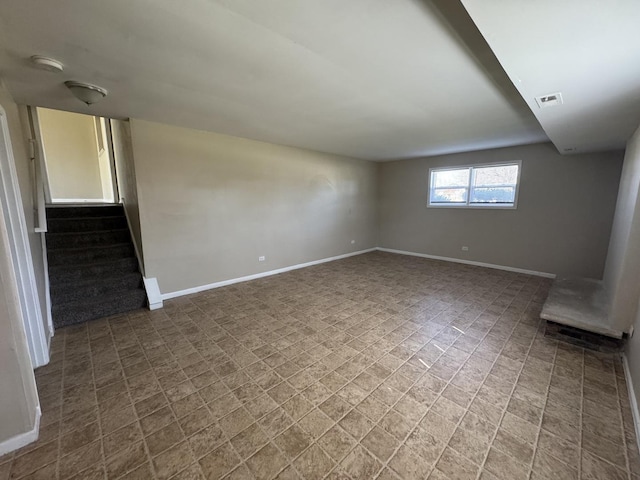 empty room with stairs, baseboards, and visible vents