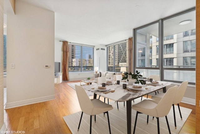 600 N Lake Shore Dr Unit 1309, Chicago, IL 60611 - dining space with expansive windows, light wood-style flooring, and baseboards
