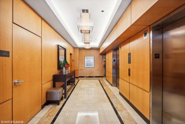 600 N Lake Shore Dr Unit 1309, Chicago, IL 60611 - corridor featuring a tray ceiling, elevator, and light tile patterned flooring