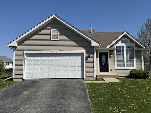 view of front of home with a garage, a front lawn, and driveway