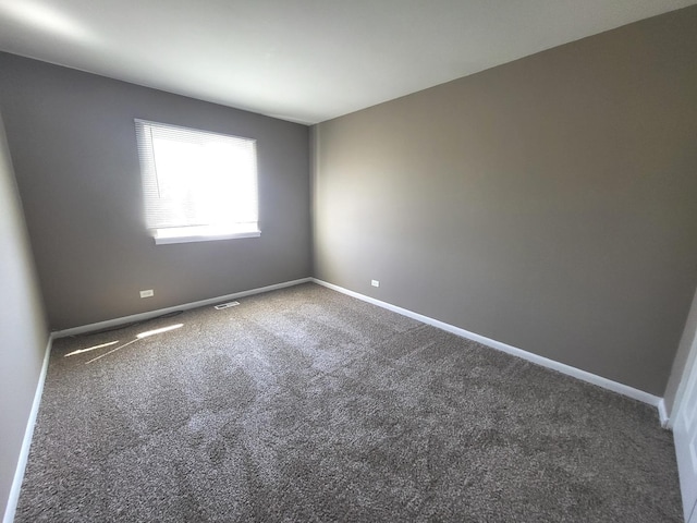 unfurnished room with carpet floors and baseboards