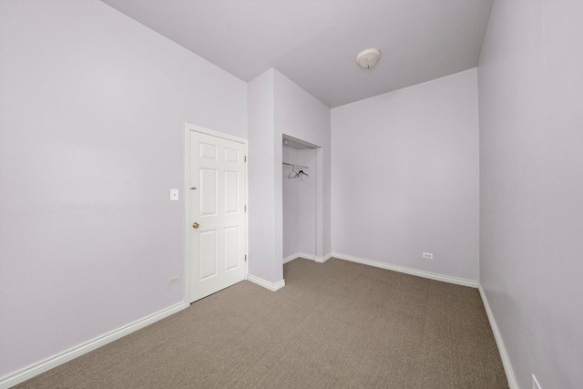 unfurnished bedroom featuring carpet floors, baseboards, and a closet