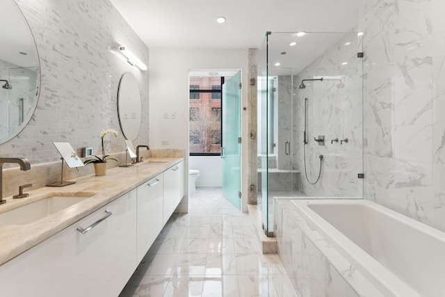 full bath featuring a sink, a marble finish shower, a bath, and marble finish floor