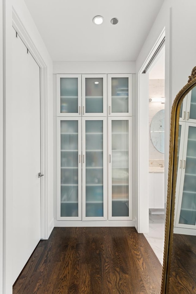 corridor featuring recessed lighting and dark wood-style floors