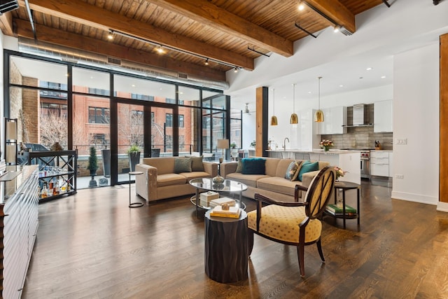 interior space with a high ceiling, a wall of windows, dark wood finished floors, beamed ceiling, and wood ceiling