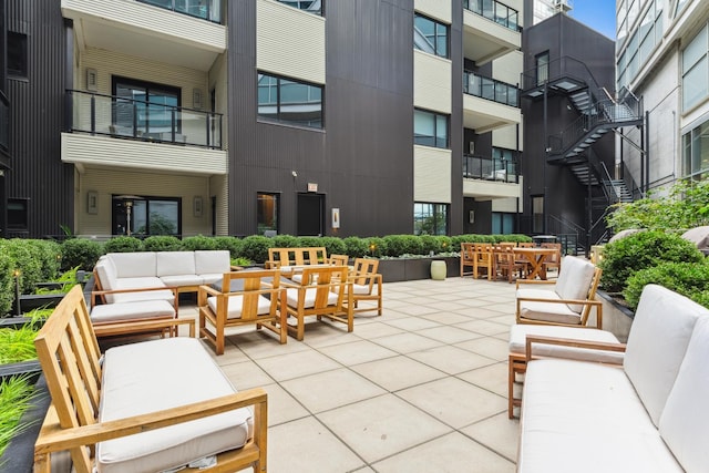 view of community with an outdoor living space and a patio area