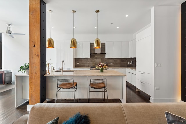 kitchen with dark wood-type flooring, a sink, modern cabinets, and white cabinets