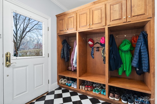 mudroom with crown molding and tile patterned floors