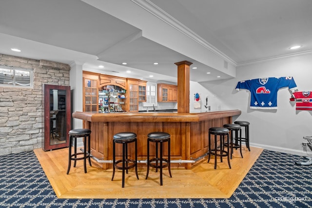 bar with recessed lighting, wet bar, and ornamental molding