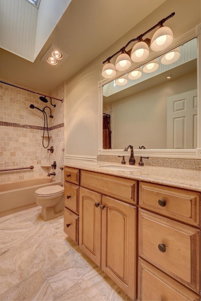 bathroom featuring vanity, toilet, and shower / tub combo