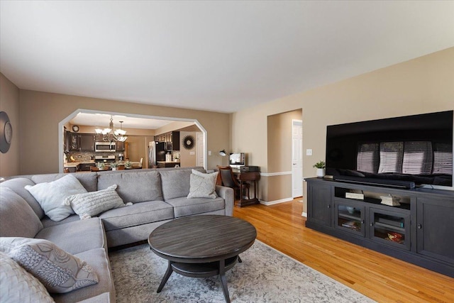 13907 W Big Run Ln, Homer Glen, IL 60491 - living room with a chandelier, light wood-type flooring, and arched walkways