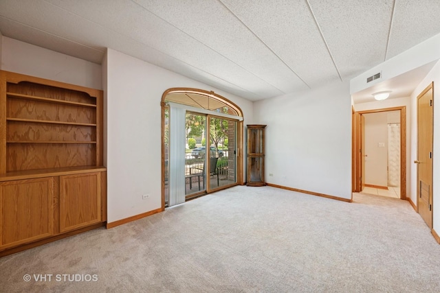 9439 S 79th Ave Unit 102, Hickory Hills, IL 60457 - spare room with light carpet, baseboards, and a textured ceiling