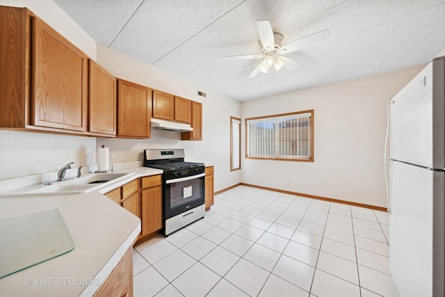 9439 S 79th Ave Unit 102, Hickory Hills, IL 60457 - kitchen with gas range, freestanding refrigerator, a sink, under cabinet range hood, and light countertops