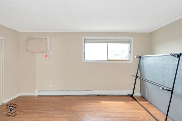 empty room with light wood-style floors, ornamental molding, a textured ceiling, baseboards, and a sink