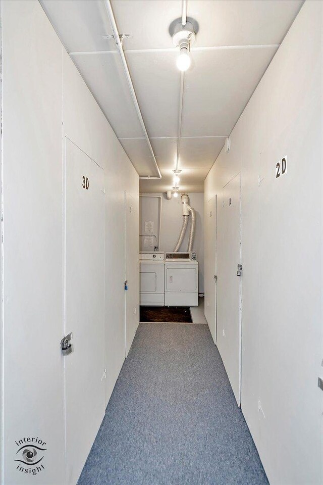 hall featuring independent washer and dryer and carpet
