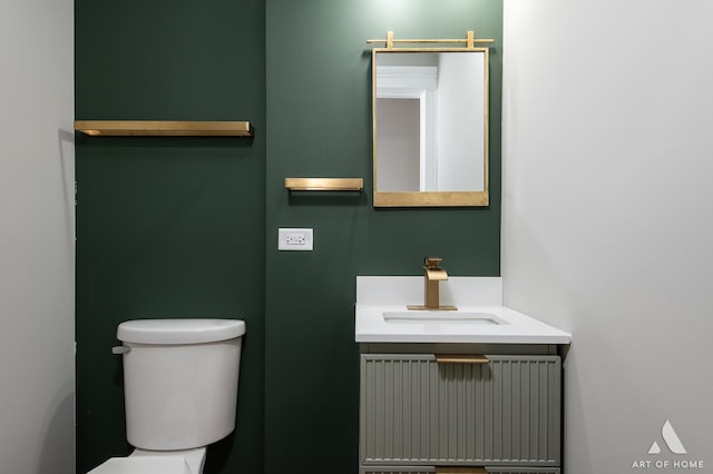 half bathroom with radiator, vanity, and toilet