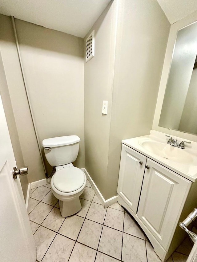 bathroom featuring visible vents, tile patterned flooring, vanity, toilet, and baseboards