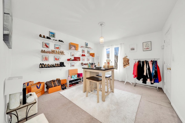 recreation room with light colored carpet