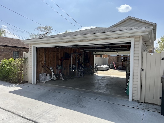 garage featuring fence and a gate