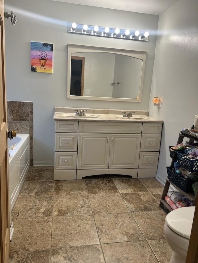 full bathroom featuring baseboards, a sink, a bath, and double vanity