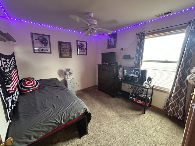 bedroom featuring baseboards, ceiling fan, carpet flooring, and visible vents